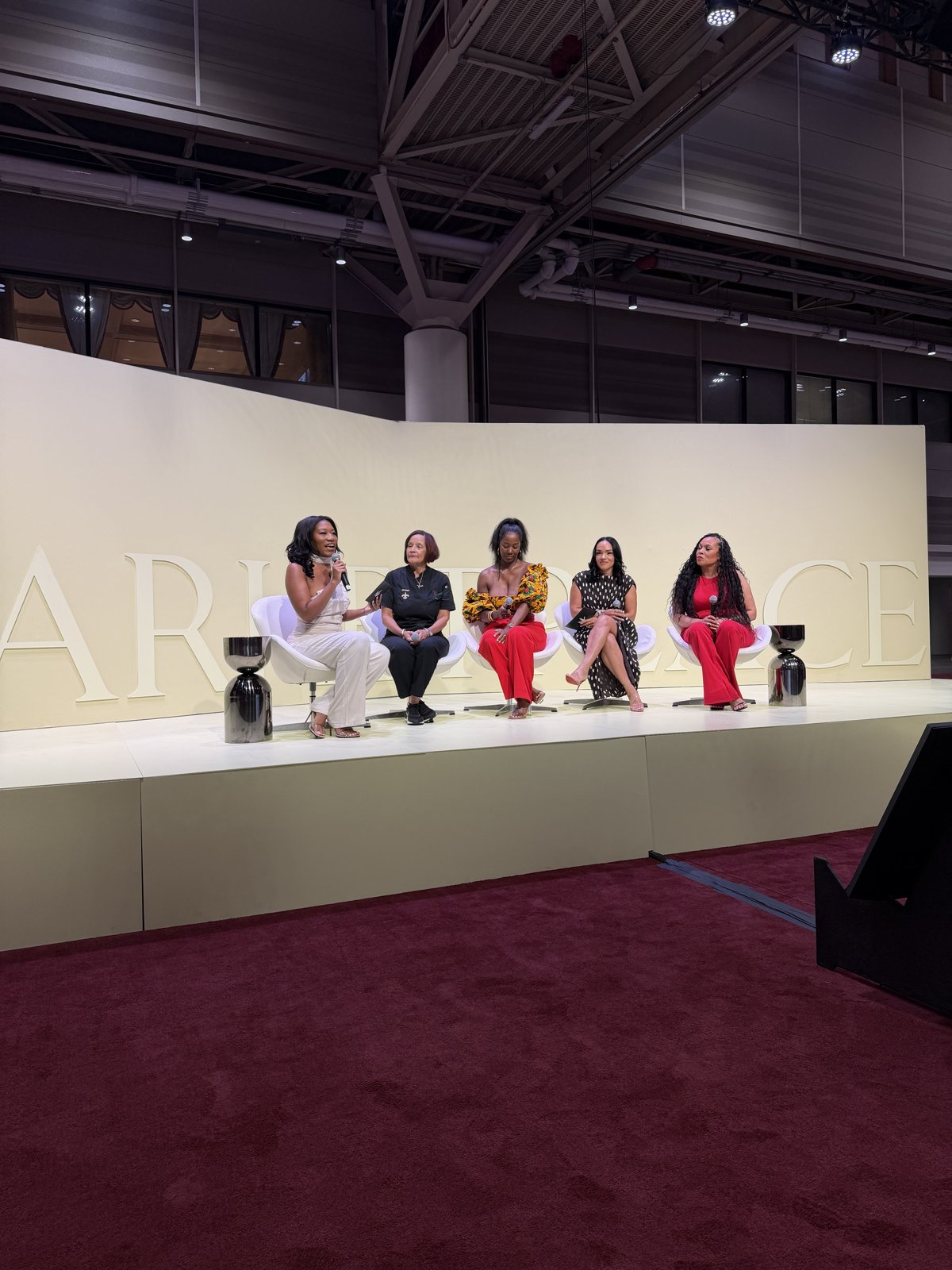 Client speaking on a panel stage at the ESSENCE Festival of Culture Marketplace